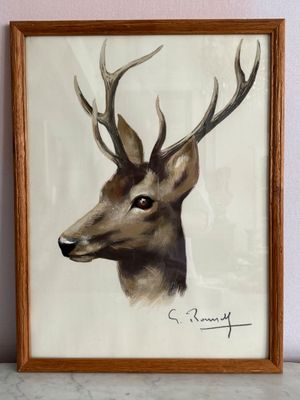 tableau représentant un cerf avec des bois sur la tête, dans un cadre en bois