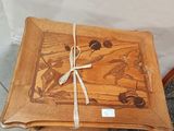 a wooden tray with a picture on it sitting on a chair