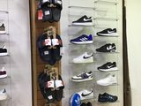 a wall of shoes and hats on display in a store
