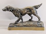 bronze statue of a dog on a wooden base on a white background