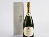 a bottle of champagne next to a silver box on a white surface