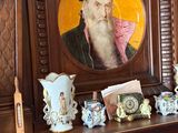 a picture of a man with a long beard and a hat on a mantle