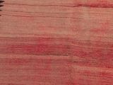an image of a red and black rug on a wooden floor