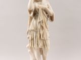 a white marble statue of a woman holding a baby