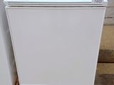 two white refrigerators sitting on a pallet next to each other