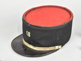 a black top hat with a red band on it