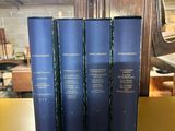 three blue books are sitting on a yellow shelf in a library