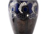 a black vase with a blue and white design on it