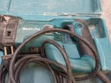 a blue box with a drill and a cord in it
