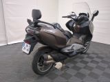 a motorcycle that is parked on a checkered floor