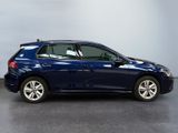 the blue volkswagen golf is parked in a room with a gray floor