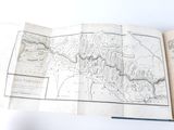 an open book with a map on it sitting on a table