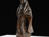 an image of a statue of a woman sitting on top of a table