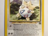 a close up of a pokemon card on a white surface