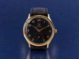 an image of a gold wrist watch on a blue surface