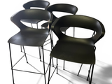 three black chairs sitting next to each other on top of a white floor