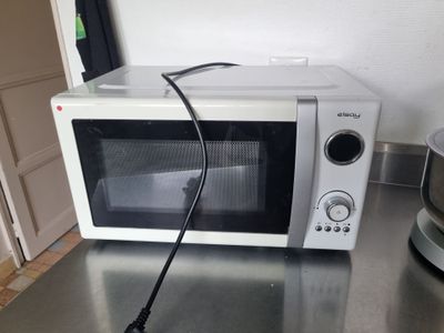 a microwave that is sitting on a counter with a blender