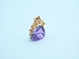 a close up of a ring with a purple stone in it