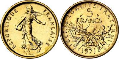 a close up of a gold coin with a woman on it