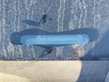 a blue sticker on the windshield of a car