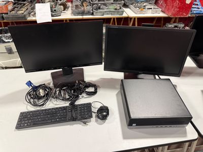 two computer monitors and a keyboard on a desk