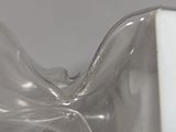 a close up of a clear glass vase on a table