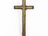 a wooden cross on a white surface with a white background