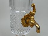 a gold faucet with a handle on a white table