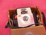 a box with a camera inside of it on a pink surface