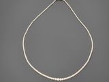 a white pearl necklace with a silver clasp