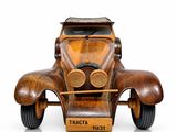 a wooden model of a car on display on a white surface