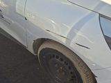 a picture of a car that has been dented and is parked on the side of the road