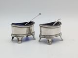 pair of silverplated salt and pepper shakers with spoons