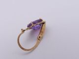 an image of a ring with a purple stone on it