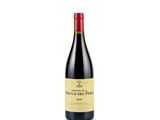 a bottle of red wine sitting on top of a white table