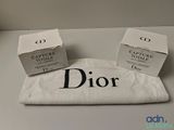 deux coffrets de parfum Dior posés sur une table blanche