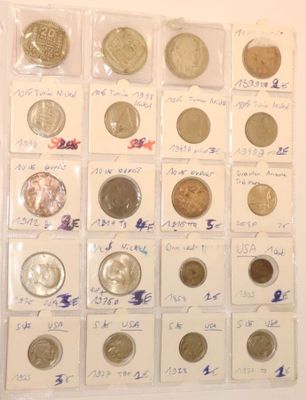 a lot of different coins in a display case