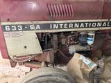 a close up of a red tractor with a sign on it