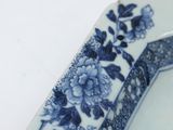 a blue and white plate with blue flowers on it