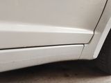 a close up of a white car with a flat tire