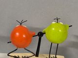three birds that are standing on a block