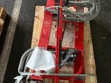a red machine that is sitting on top of a pallet