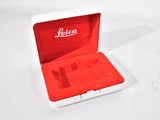a red and white box with a watch inside of it