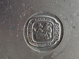 a close up of a silver plate with a seal on it