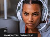 a woman wearing headphones sitting in front of a computer