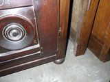 a wooden cabinet with a metal door and a door handle
