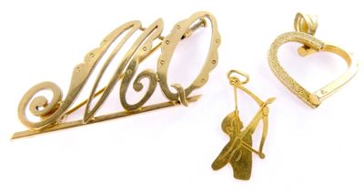 three pieces of gold jewelry on a white surface