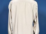a white shirt on a mannequin stand against a blue wall