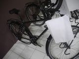 a black bike with a white bag on the back of it