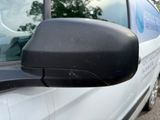 a side view mirror of a white van parked on the side of the road